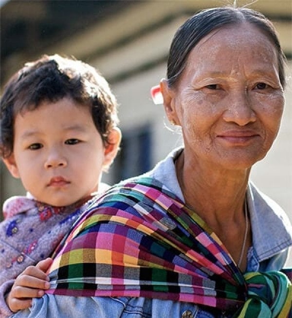Photo of Daw Ngwe Tein babysitting her grandchild, Blu Nay L’Paw featured in Roche Diagram healthcare publications. Blu’s mother works as a medic in one of the field clinics of the Shoklo Malaria Research Unit in Mae Sot, Thailand.